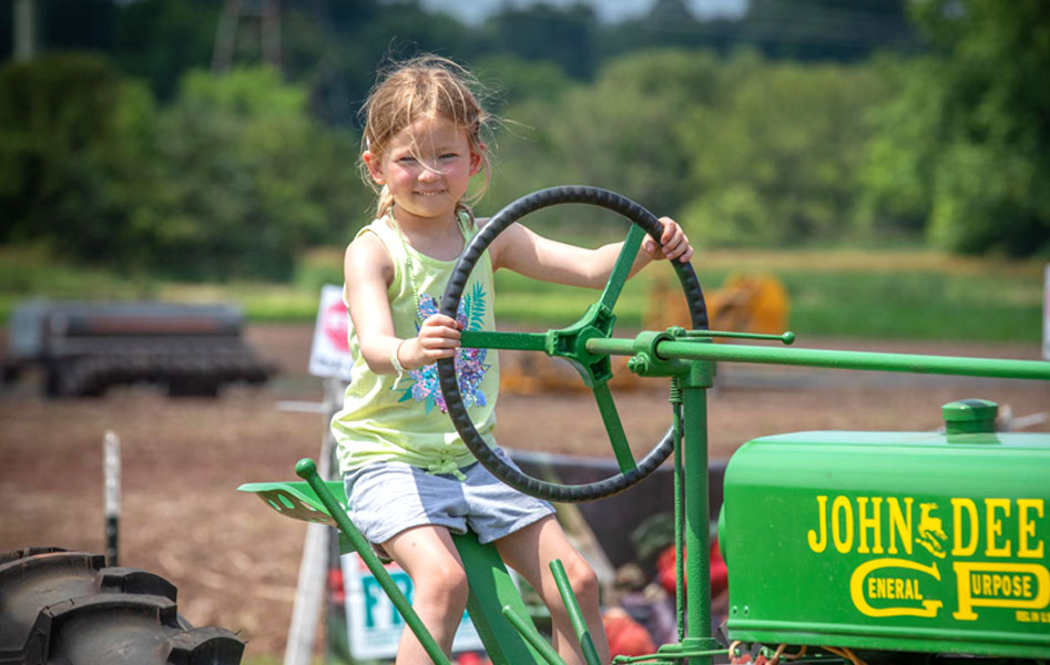 norz-hill-farm-girl-on-tractor.jpg