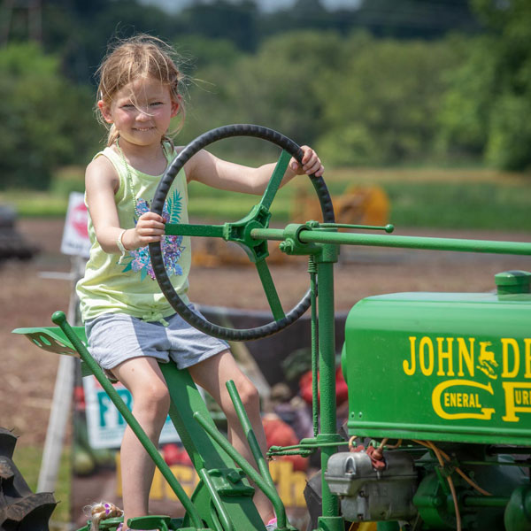 norz-hill-farm-girl-on-tractor-tn.jpg